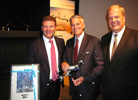 Jens Bischof et Hans DeHaan de Lufthansa entourent Pierre-Paul Pharand de Aéroports de Montréal suite à un échange de cadeaux remarquables.